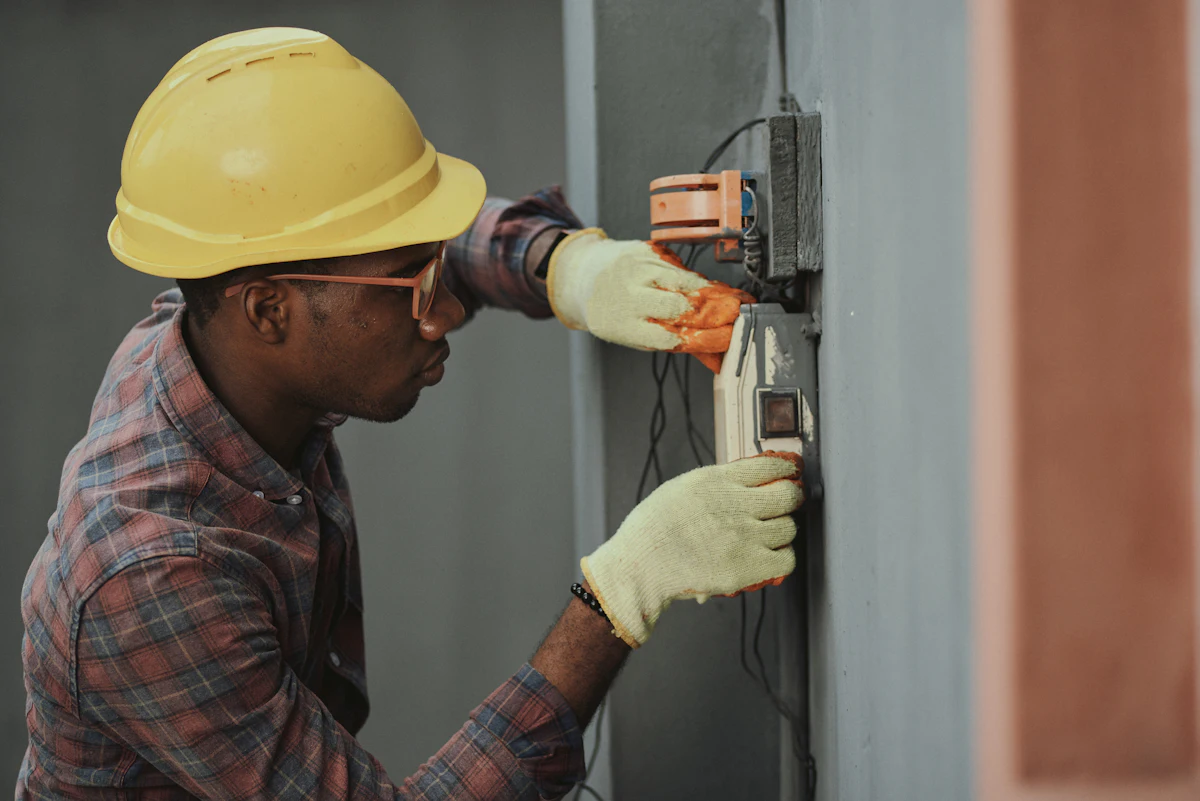 An electrician installing wiring on a service call
