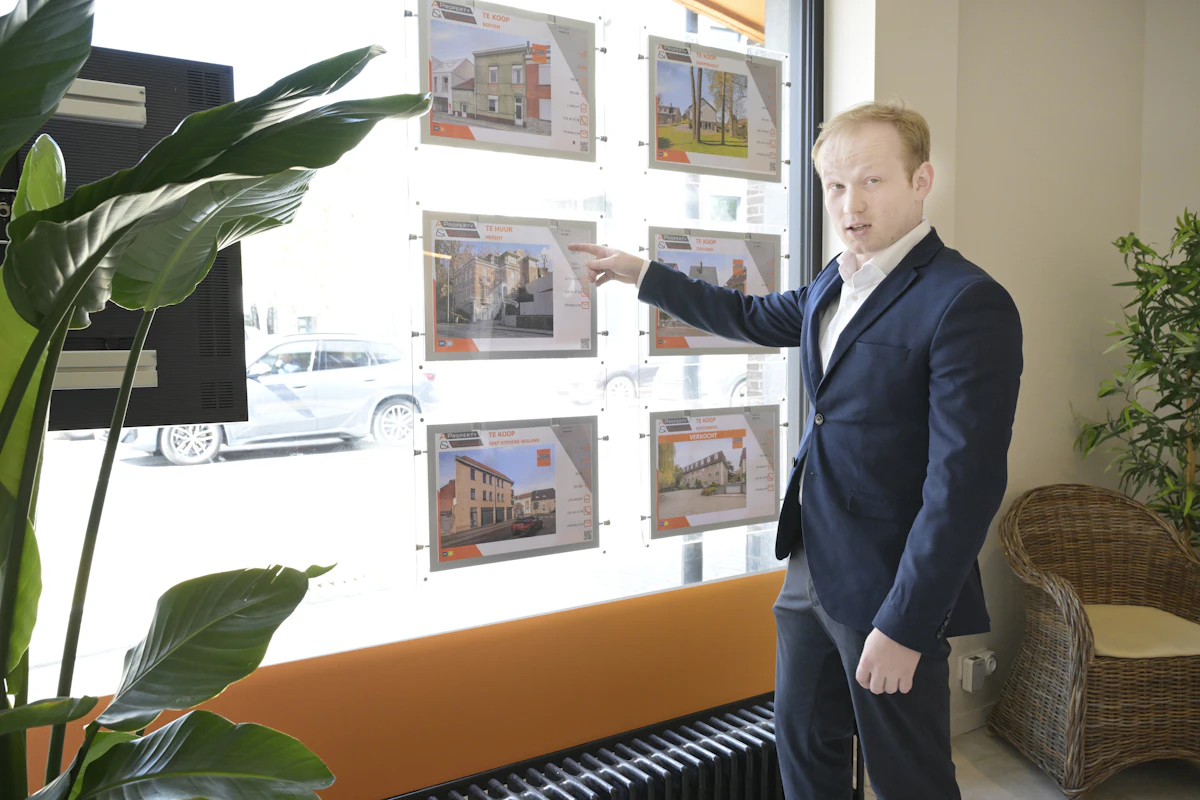 A real estate agent walking a client through property listings